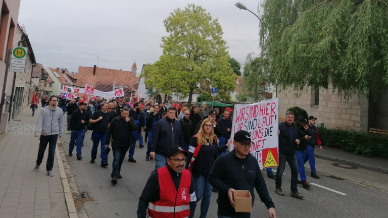 Die Beschäftigten von ElringKlinger demonstrieren mit IG Metall-Fahnen und Banner wegen ihrer geplanten Betriebsschließung durch Langenzenn.